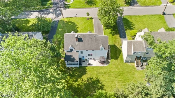 an aerial view of a house with a yard pool patio and outdoor seating