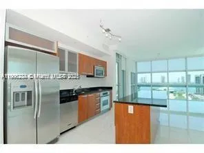 a kitchen with stainless steel appliances granite countertop a refrigerator a oven a sink and dishwasher