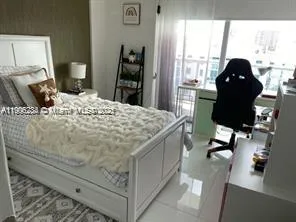 a bed sitting in a bedroom next to a window