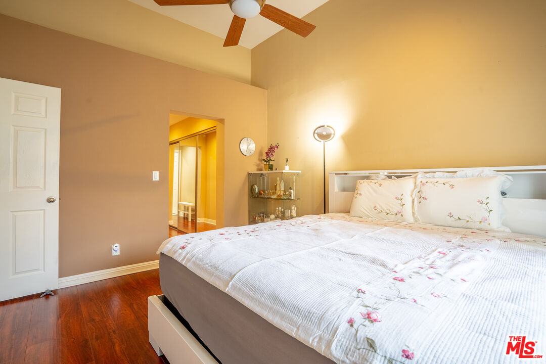 4240 Lost Hills Road, Unit 503 Agoura Hills, CA 91301 - Photo 12 of 18 a bedroom with a bed and a dresser with wooden floor