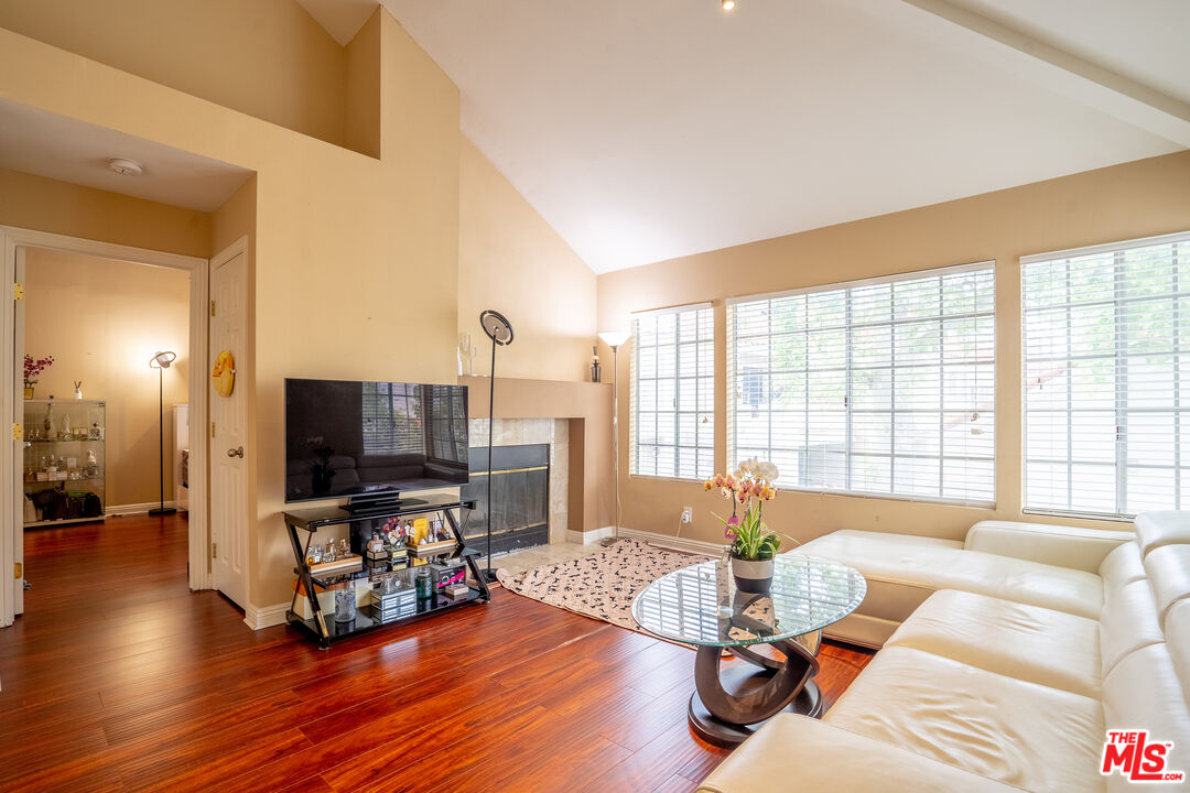 4240 Lost Hills Road, Unit 503 Agoura Hills, CA 91301 - Photo 3 of 18 a living room with furniture flat screen tv and a large window