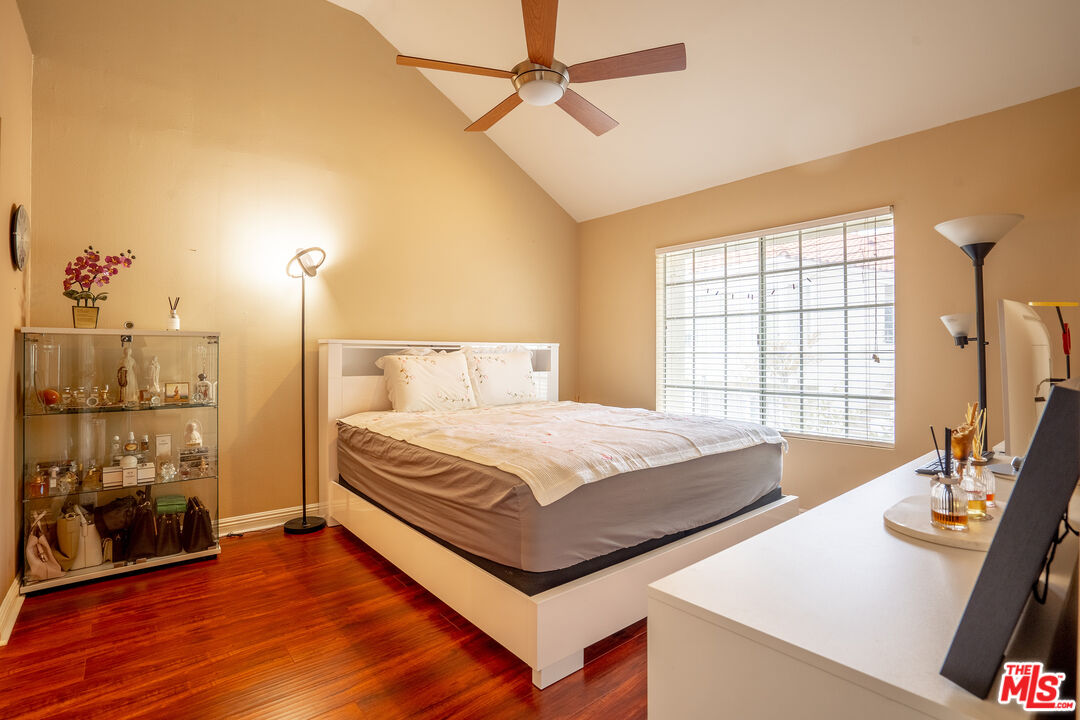 4240 Lost Hills Road, Unit 503 Agoura Hills, CA 91301 - Photo 6 of 18 a bedroom with a bed and a table with wooden floor