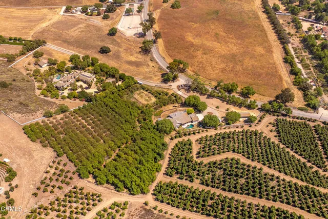 an aerial view of a house with a mountain