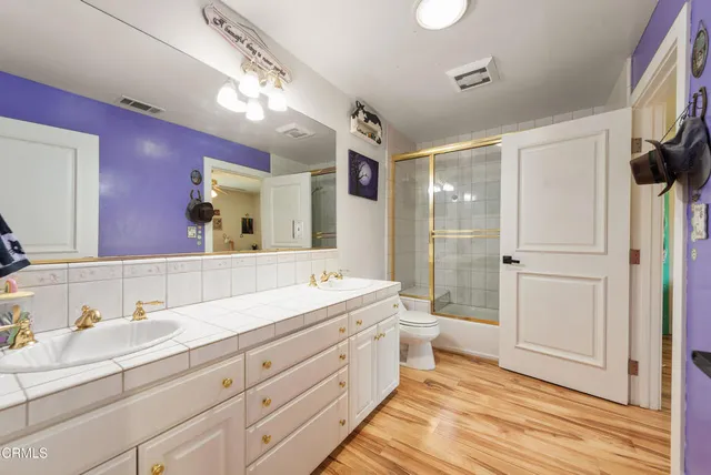 a kitchen with stainless steel appliances granite countertop wooden floors and table