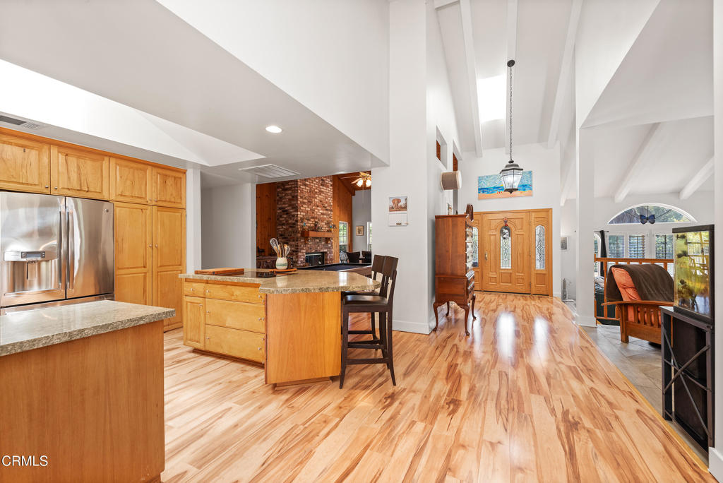 4850 North Moorpark Road Thousand Oaks, CA 93021 - Photo 39 of 54 a kitchen with stainless steel appliances granite countertop wooden floors and table
