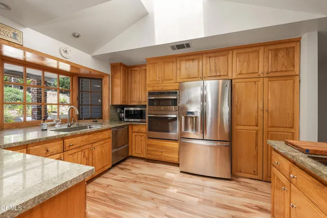 a dining room with furniture a fireplace and wooden floor