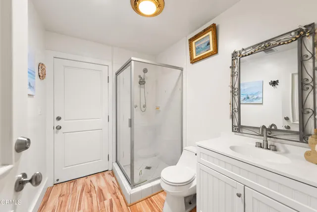 a spacious bathroom with a shower sink and mirror