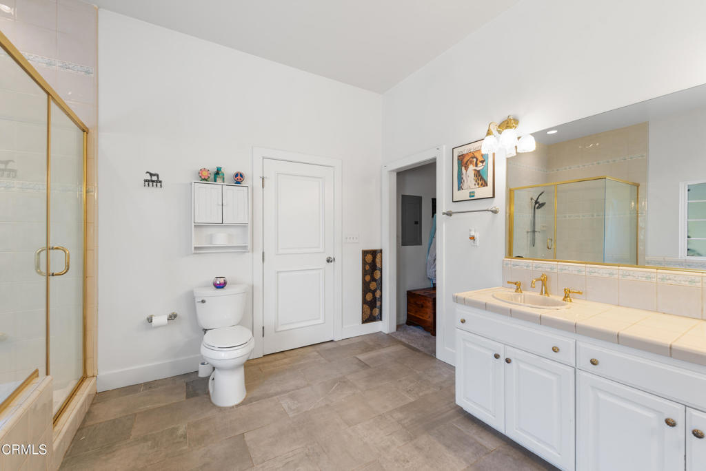 4850 North Moorpark Road Thousand Oaks, CA 93021 - Photo 51 of 54 a spacious bathroom with a shower sink and mirror