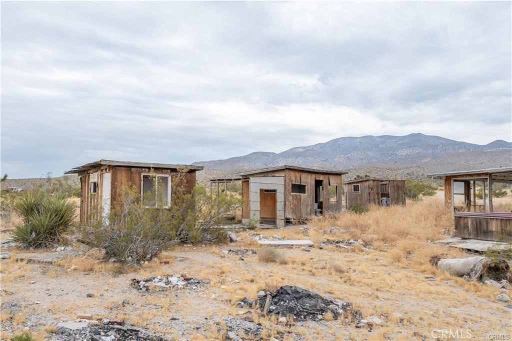 37050 Cheshire Road Lucerne Valley, CA 92356 - Photo 6 of 8 a front view of a house with a yard covered in snow