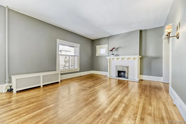 a kitchen with white cabinets and refrigerator