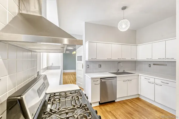a kitchen with a sink stove and cabinets