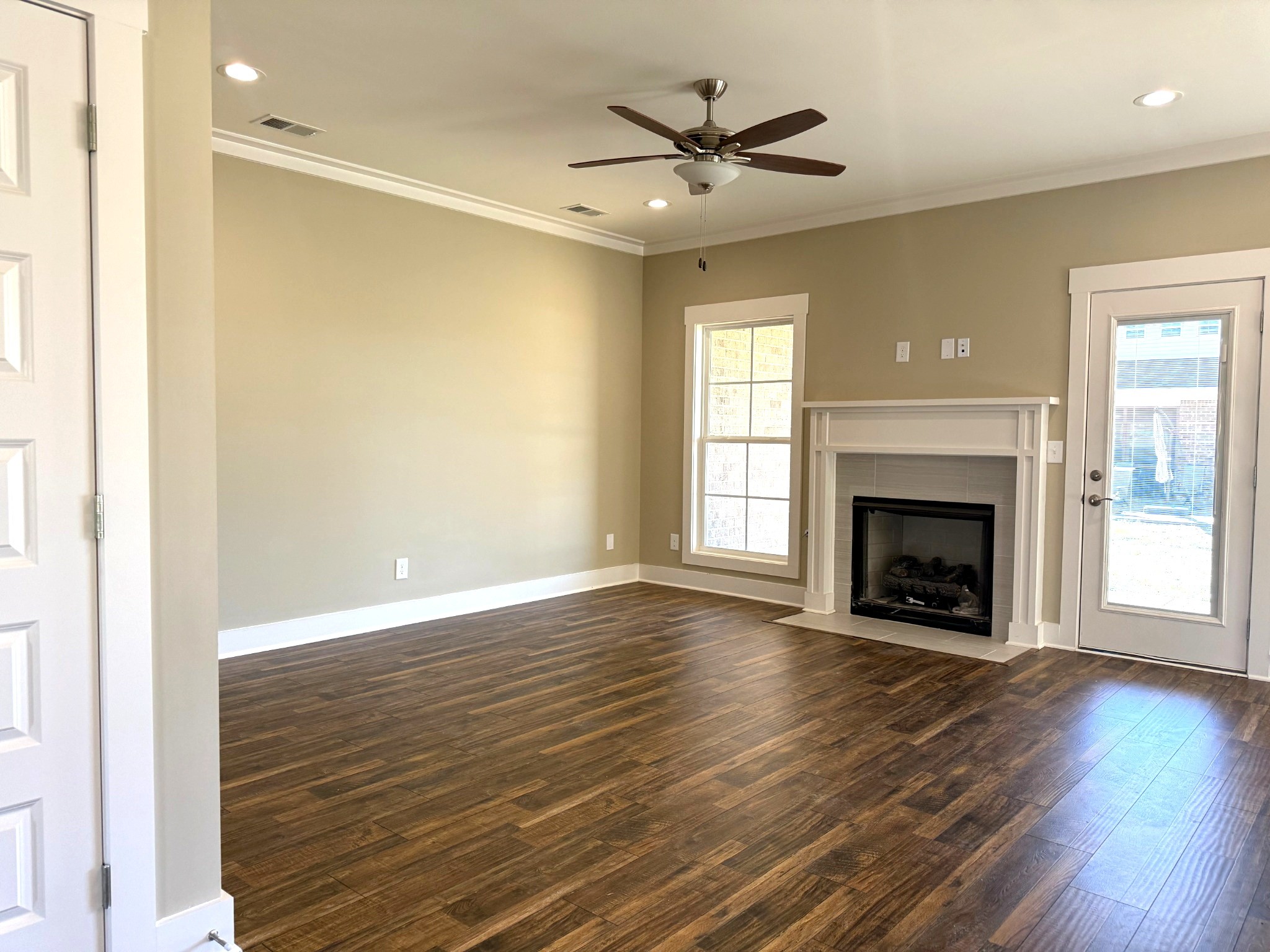 1172 Rimrock Road Smyrna, TN 37167 - Photo 6 of 10 an empty room with wooden floor a fireplace and window