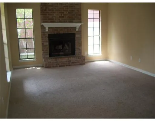 a view of empty room with a fireplace