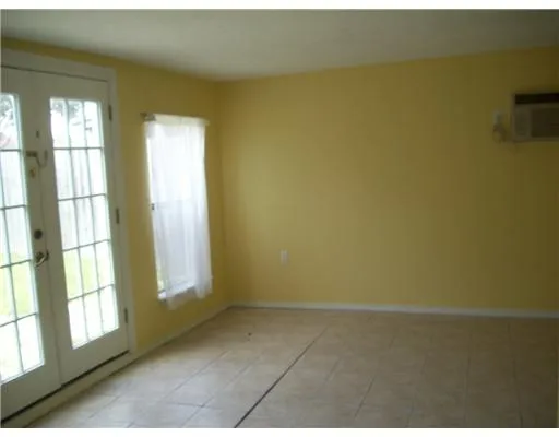 a view of an empty room with a window