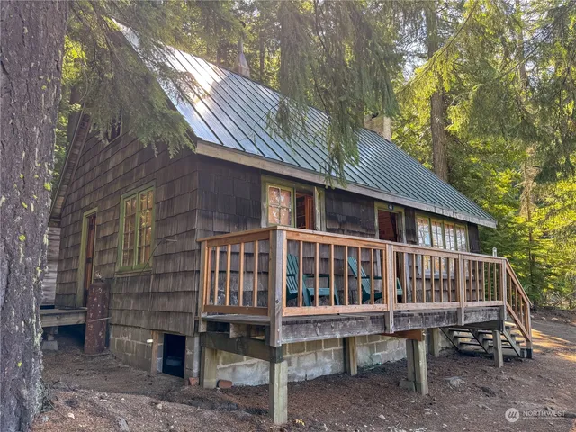 a view of a house with a yard and deck
