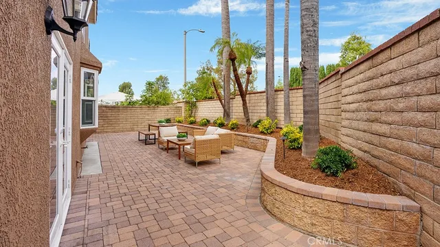 a pathway of a house with wooden fence