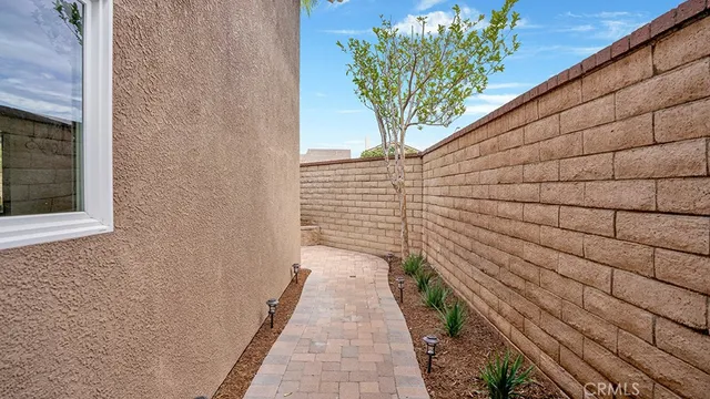 an aerial view of a house with a yard and potted plants