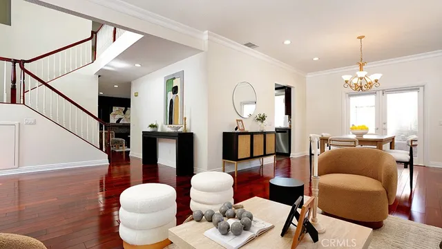 a living room with furniture chandelier and a table