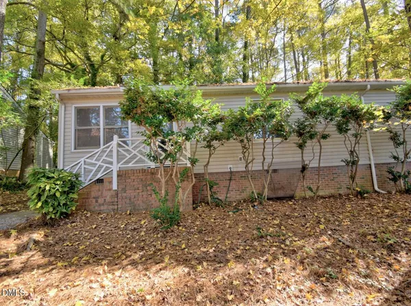 a view of a house with a yard and sitting area