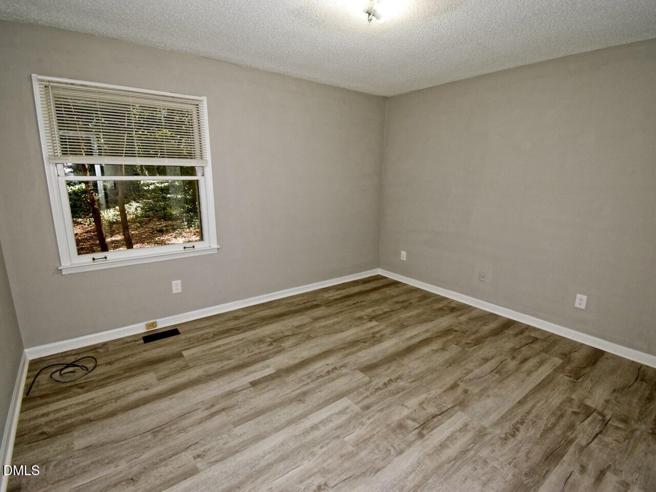 841 Barringer Drive, Unit A Raleigh, NC 27606 - Photo 11 of 23 an empty room with a window