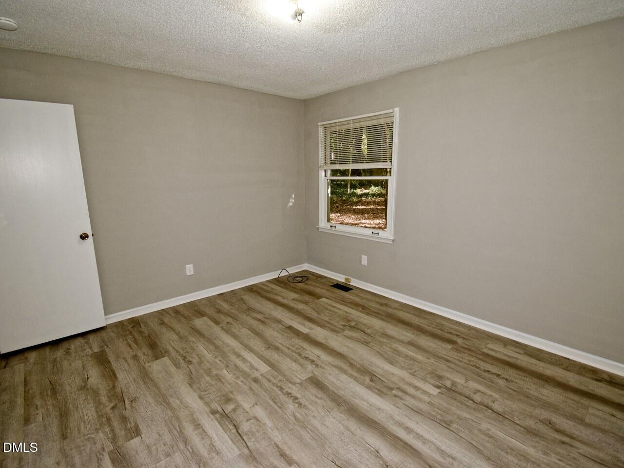 841 Barringer Drive, Unit A Raleigh, NC 27606 - Photo 12 of 23 an empty room with a window
