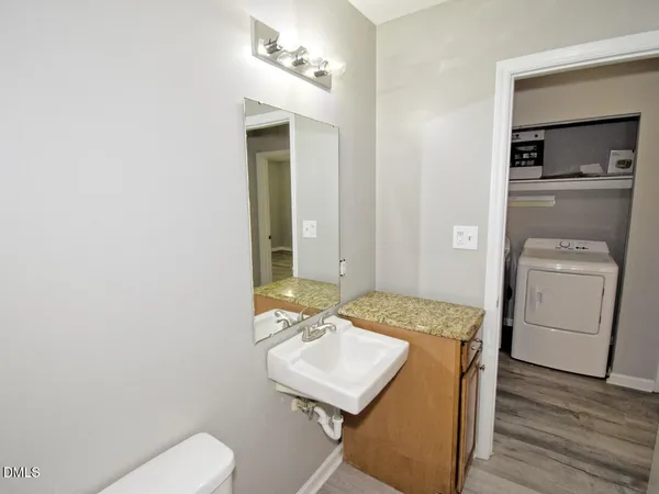 a bathroom with a sink toilet and mirror