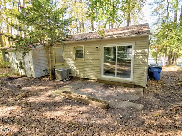 a view of a house with a yard and tree
