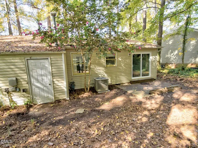a view of a house with a large tree