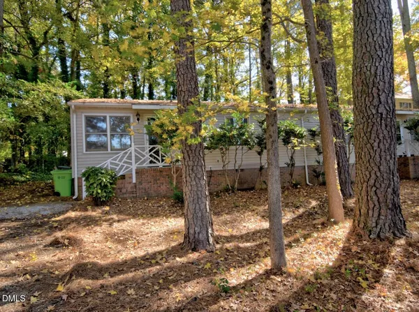 a view of a house with a tree in the yard
