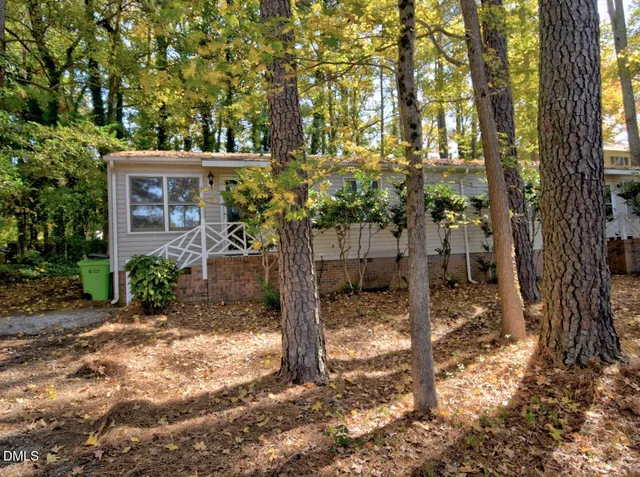 a view of a house with a tree in the yard