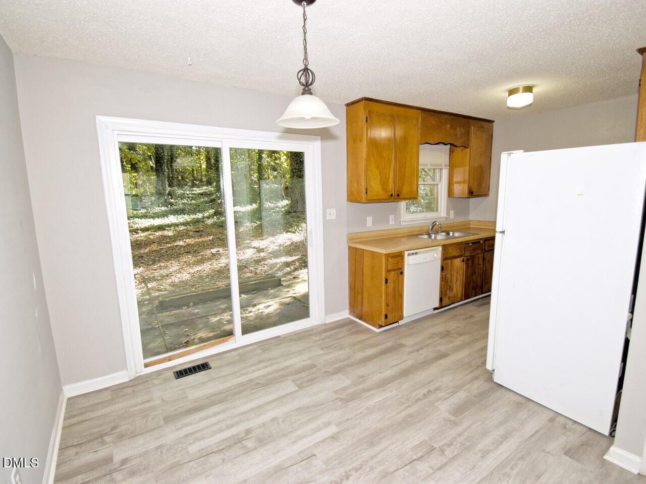 841 Barringer Drive, Unit A Raleigh, NC 27606 - Photo 7 of 23 a view of a kitchen with a sink and wooden floor