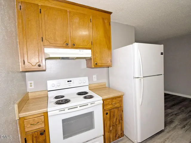 a kitchen with a stove a refrigerator and a stove