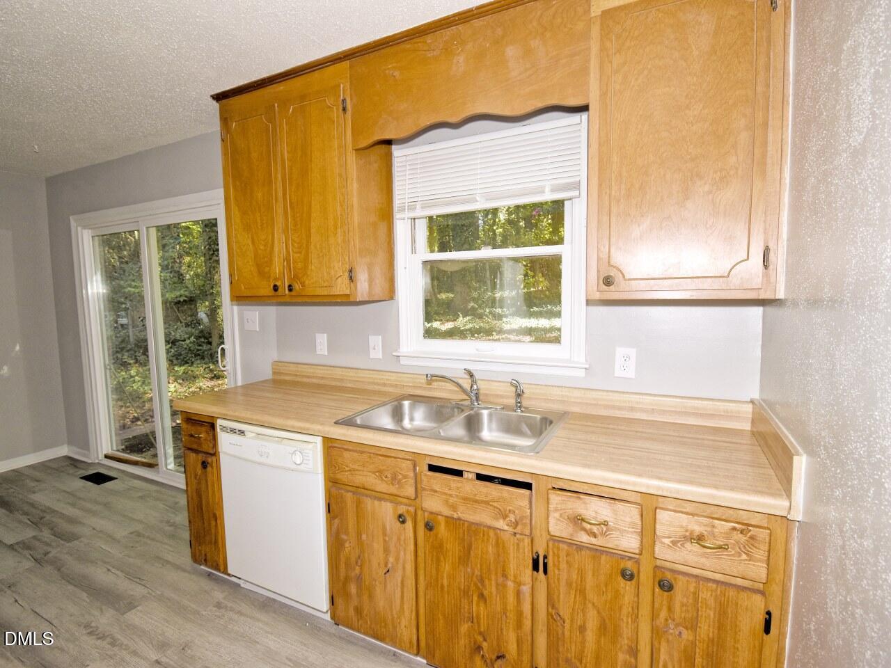 841 Barringer Drive, Unit A Raleigh, NC 27606 - Photo 10 of 23 a kitchen with a sink cabinets and window