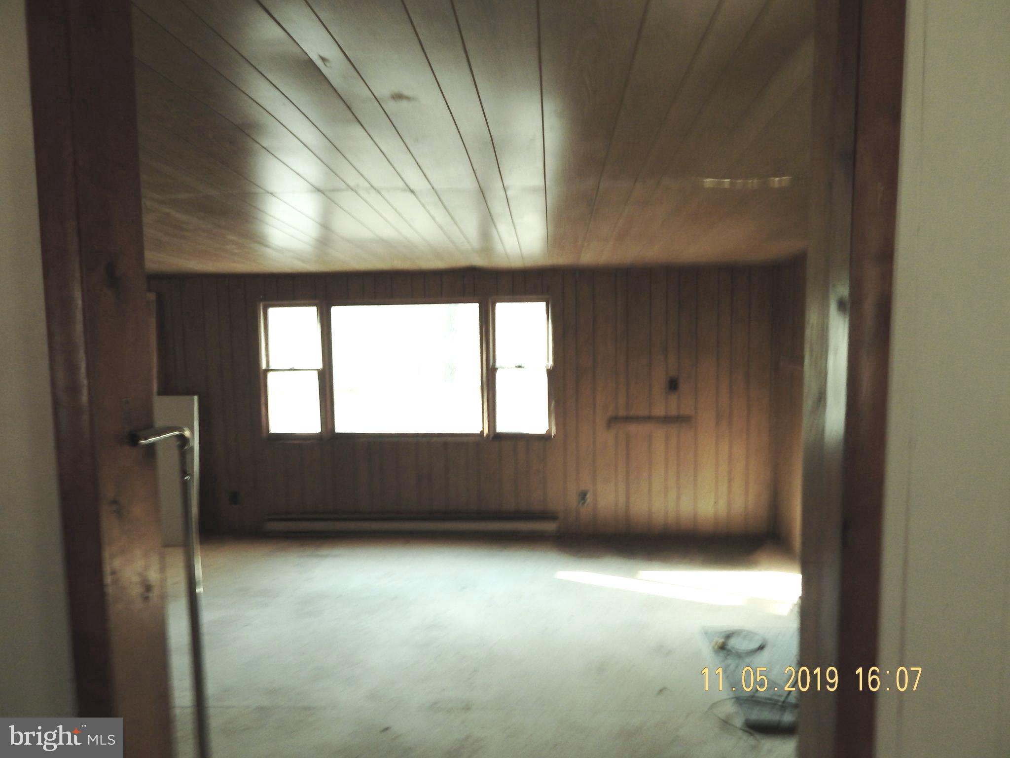 4040 Wv Route Berkeley Springs, WV 25411 - Photo 13 of 28 Living room with handicap bar for step down.