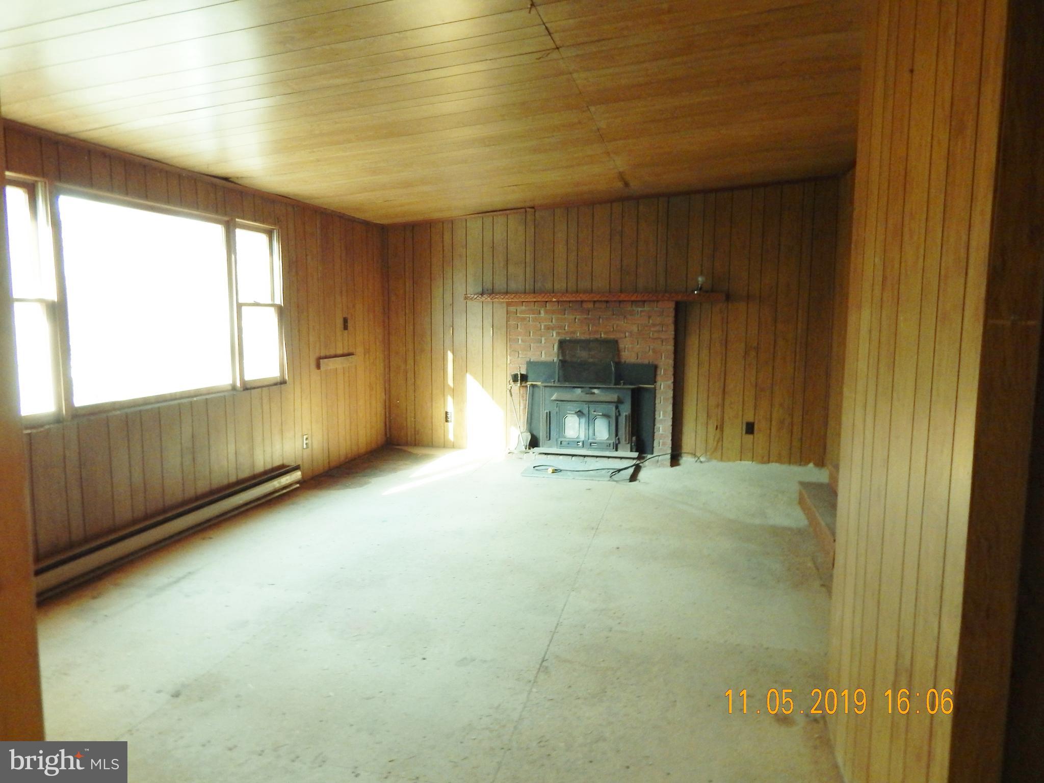 4040 Wv Route Berkeley Springs, WV 25411 - Photo 5 of 28 Living room with wood stove.