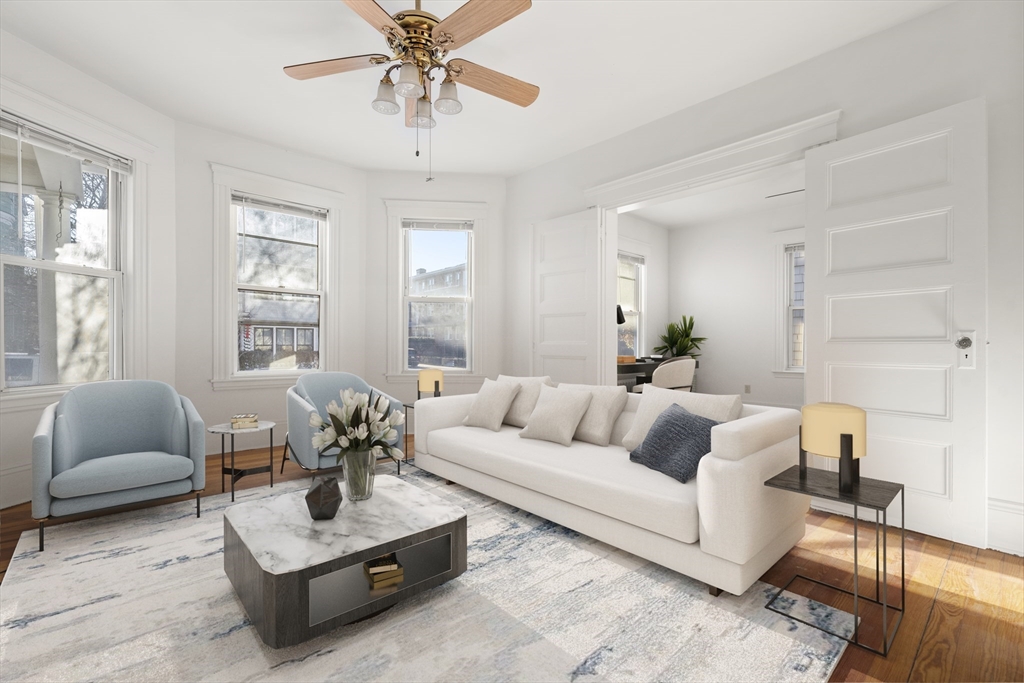 27 Willis Street Boston, MA 02125 - Photo 2 of 9 a living room with furniture and a large window