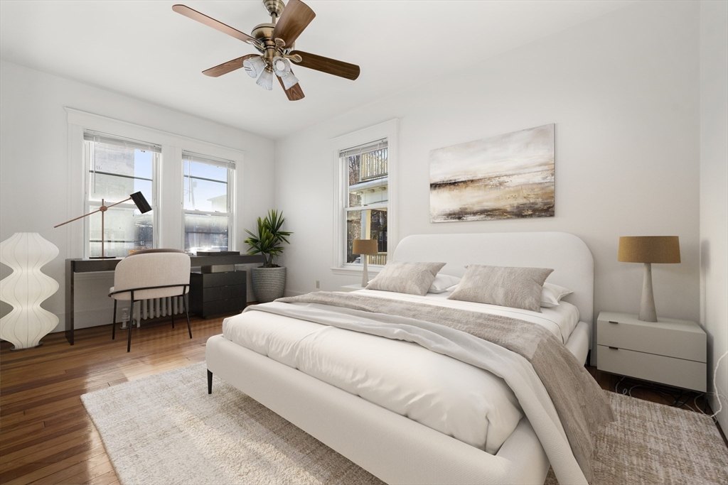 27 Willis Street Boston, MA 02125 - Photo 6 of 9 a bedroom with a bed and a chandelier