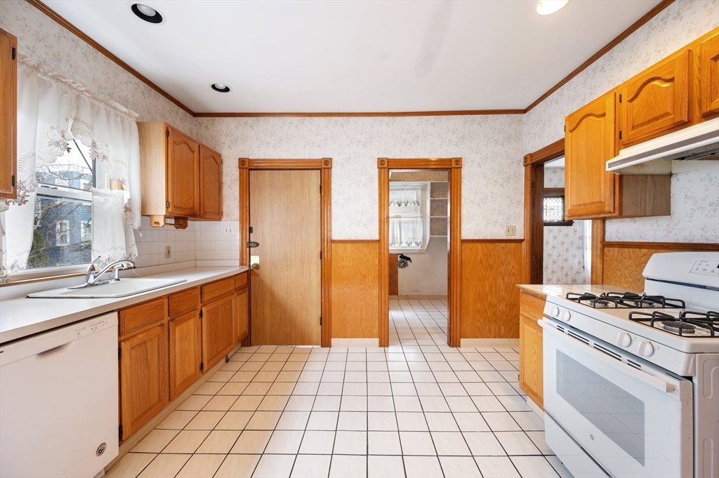 27 Willis Street Boston, MA 02125 - Photo 7 of 9 a kitchen with stainless steel appliances a stove a sink and a refrigerator