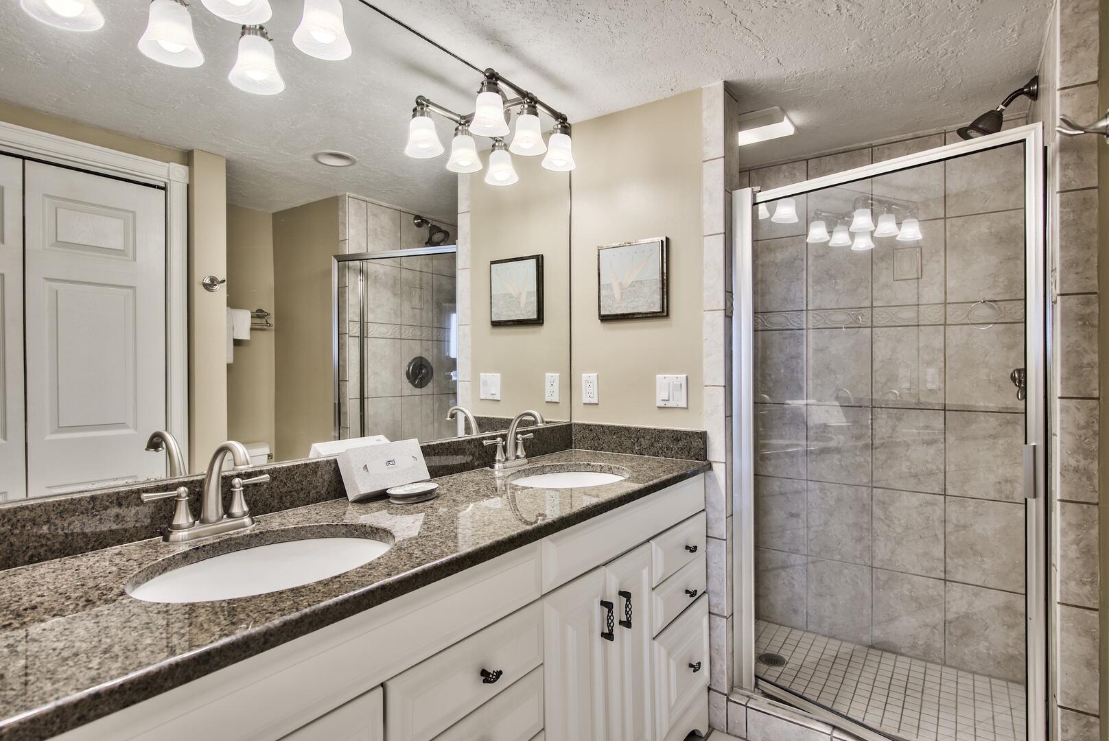 500 Gulf Shore Drive, Unit 119B Destin, FL 32541 - Photo 14 of 35 a bathroom with a granite countertop double vanity sink and mirror