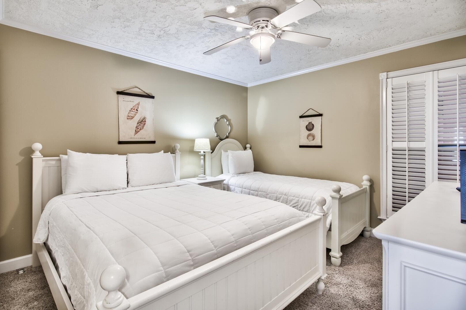 500 Gulf Shore Drive, Unit 119B Destin, FL 32541 - Photo 15 of 35 a bedroom with a bed and a chandelier