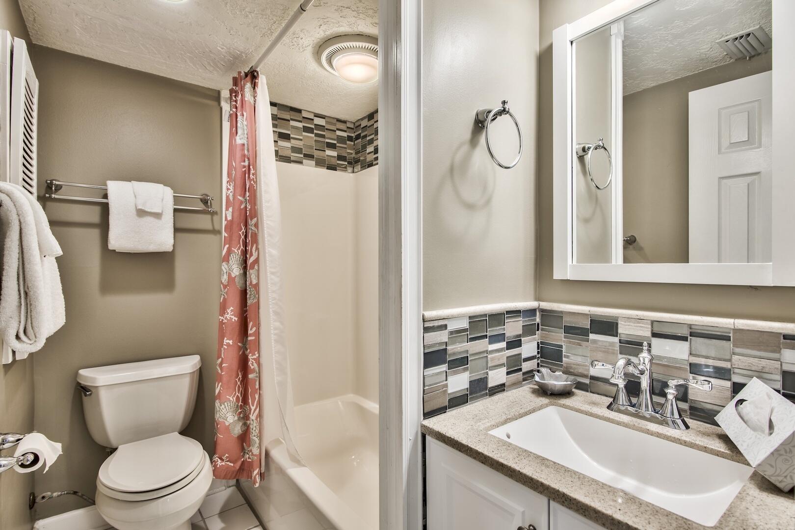 500 Gulf Shore Drive, Unit 119B Destin, FL 32541 - Photo 17 of 35 a bathroom with a sink toilet and mirror