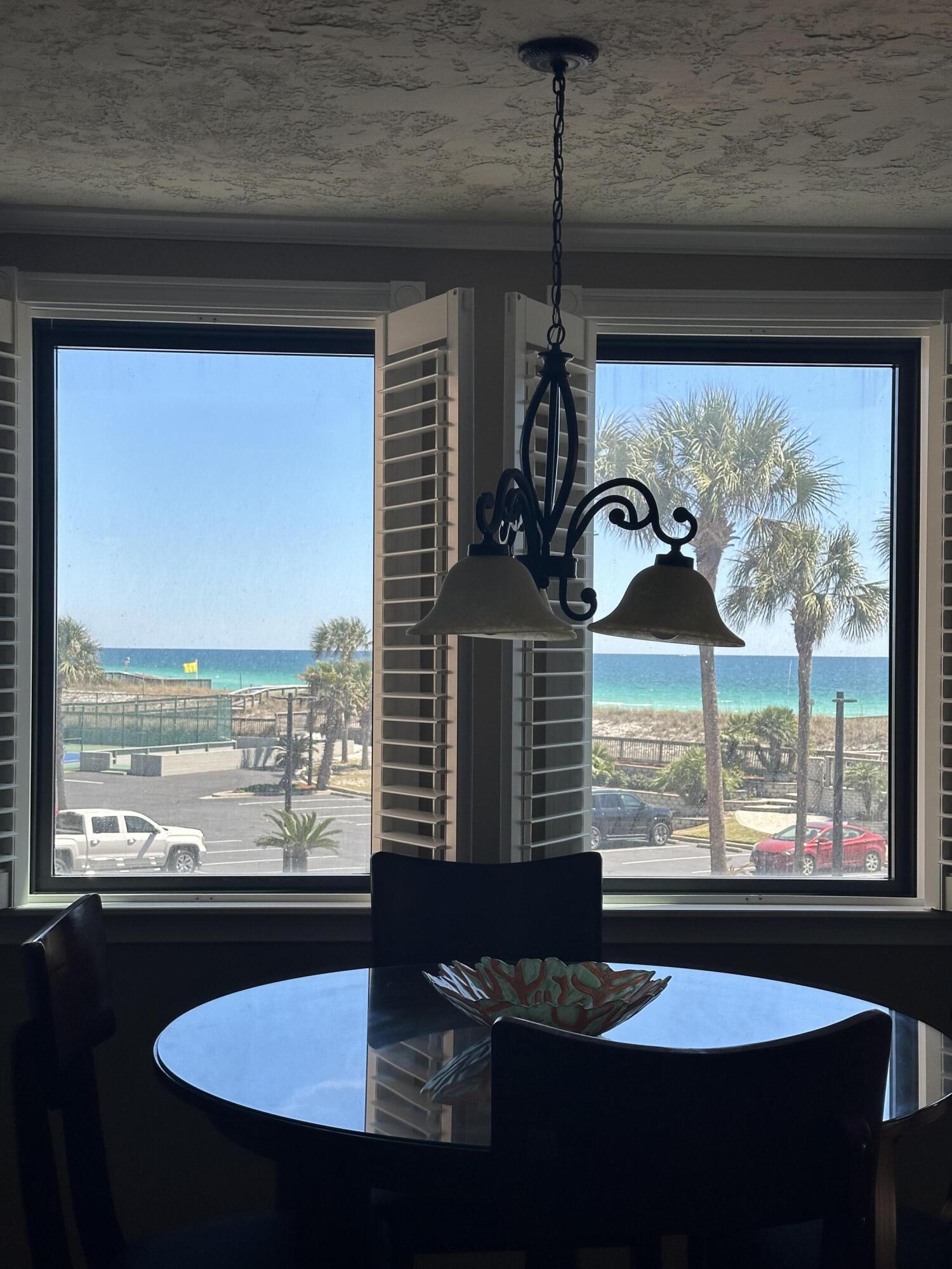500 Gulf Shore Drive, Unit 119B Destin, FL 32541 - Photo 2 of 35 a view of a balcony with table and chairs