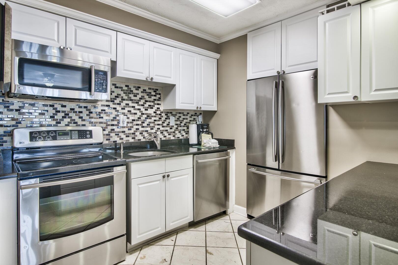 500 Gulf Shore Drive, Unit 119B Destin, FL 32541 - Photo 10 of 35 a kitchen with stainless steel appliances white cabinets and a stove a refrigerator with wooden floor