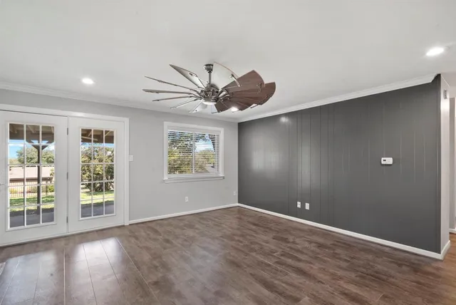 wooden floor in an empty room with a window