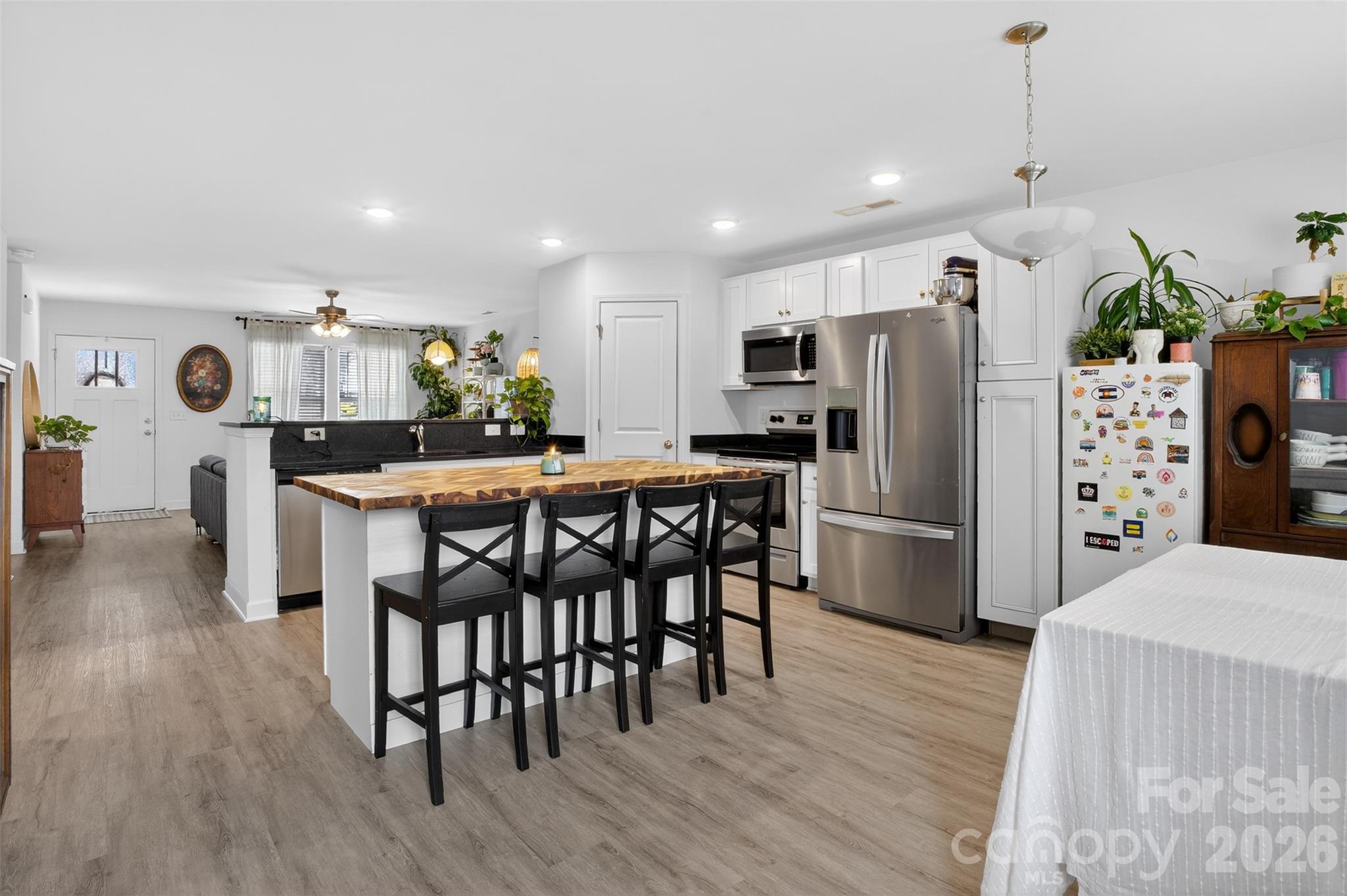 1526 Shepard Street Kannapolis, NC 28083 - Photo 13 of 40 a kitchen with stainless steel appliances a dining table chairs refrigerator and microwave