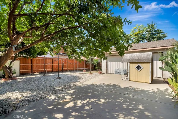 an aerial view of a house with a yard and a large tree