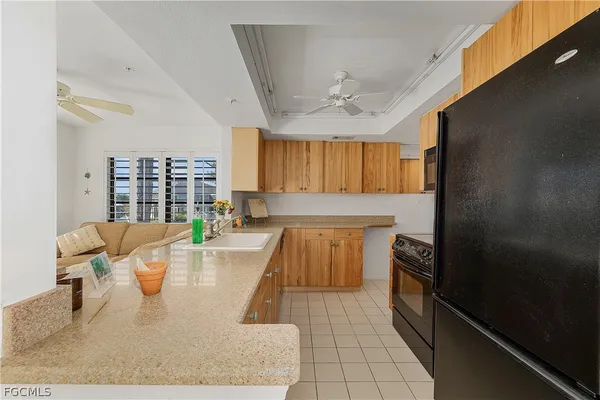 a large white kitchen with a large window