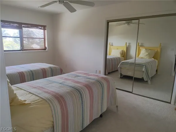 a bedroom with two beds and a window