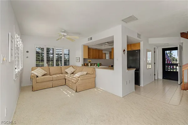 a living room with furniture and large window