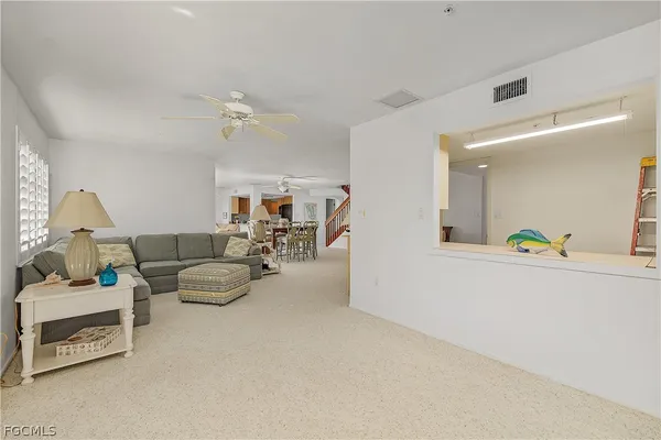 a living room with furniture and a lamp